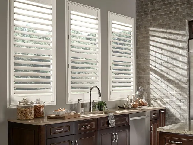 Can wooden blinds be used in humid areas like kitchens or bathrooms?